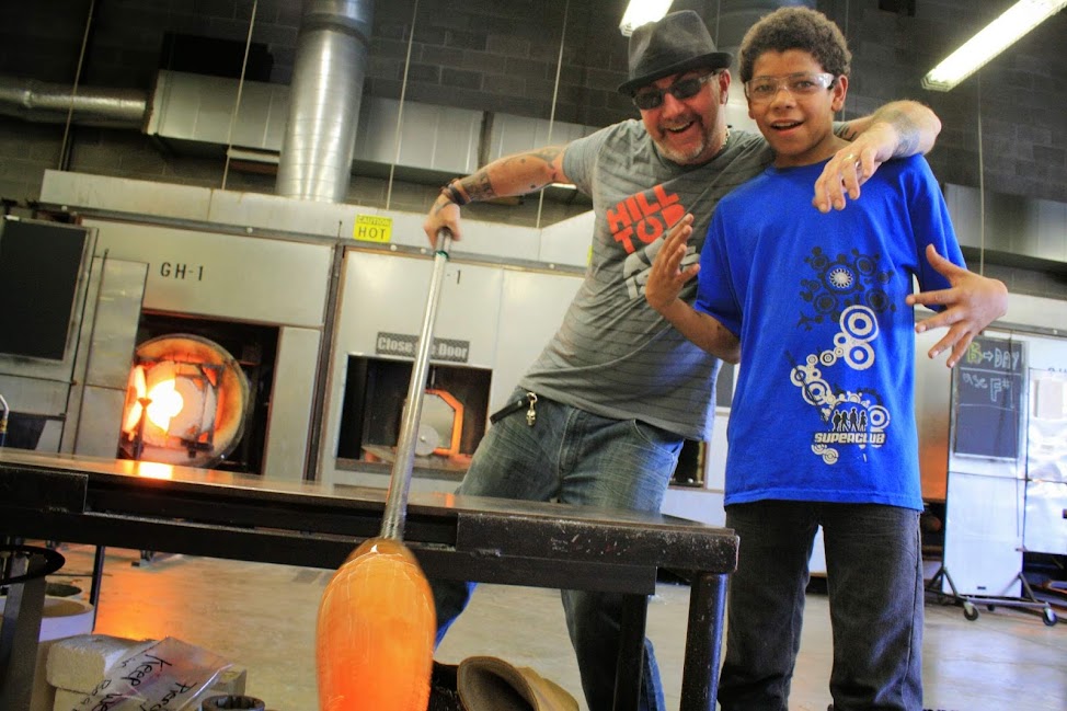 Hilltop Artists instructor Greg Piercy poses with a student in the hot shop