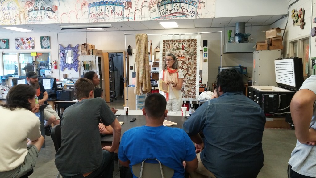 Photograph of a visiting instructor giving a presentation to Hilltop Artists After-School students