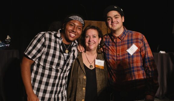 Hilltop Artists MiShawn and Jacob pose with Outreach Manager Kathy Anderson