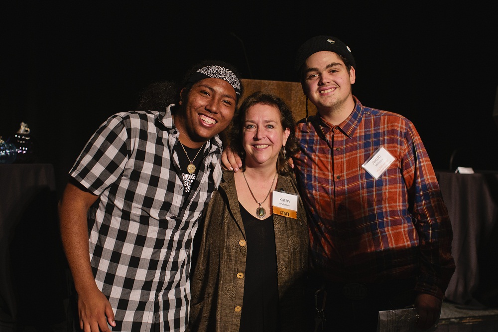 Hilltop Artists MiShawn and Jacob pose with Outreach Manager Kathy Anderson
