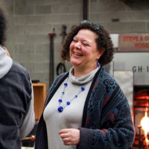 Photograph of Hilltop Artists' Executive Director Dr. Kim Keith chatting with students