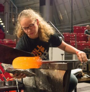 Hilltop Artist Nikki works on a glass piece during a demonstration at Museum of Glass