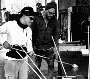 Nate Watson works with Hilltop Artists student Sean at Pilchuck Glass School