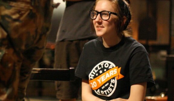 Hilltop Artist student Dani in the hot shop at Museum of Glass during a residency demonstration.