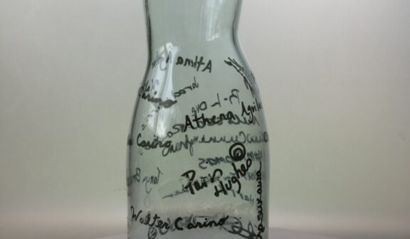 Image of a signed glass vessel created by Hilltop Artists alum, Paris.