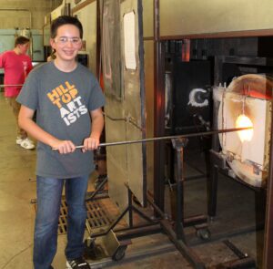 Hilltop Artist Zach in the hot shop at Hilltop Heritage MS