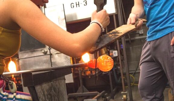 Hilltop Artists Production Students collaborate on a piece in the hot shop