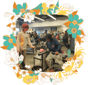 Student Eden assists visiting student artist LA during the Hilltop Artists GAS Conference party