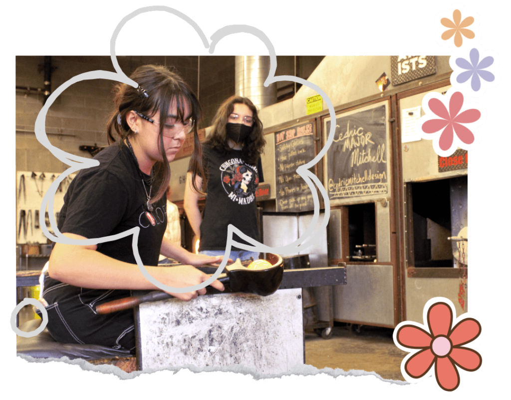 Photograph of Hilltop Artist Jasmine working on a glass piece while Lily looks on