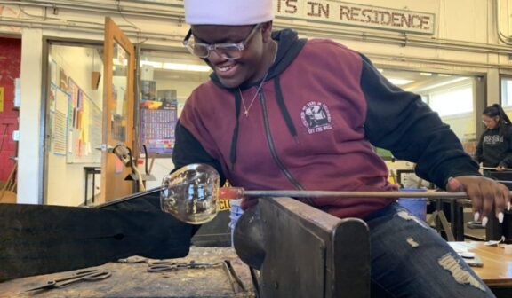 Kawii works on a glass piece in the hot shop