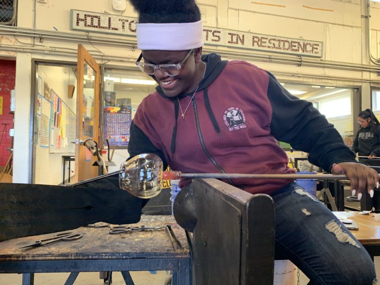 Kawii works on a glass piece in the hot shop