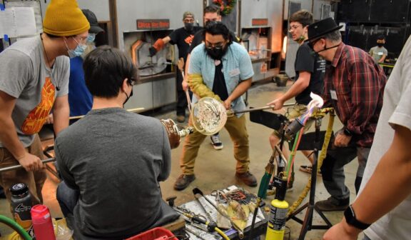 Hilltop Artists collaborate on a large, winter-themed piece in the hot shop