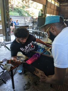 A Hilltop Artists alum works with artist Cedric Mitchell at Pilchuck Glass School