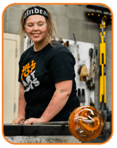 Hilltop Artist student, Dasein, works on a glass piece in the hot shop