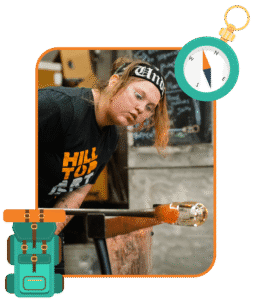 Hilltop Artist student, Dasein, works on a glass piece in the hot shop