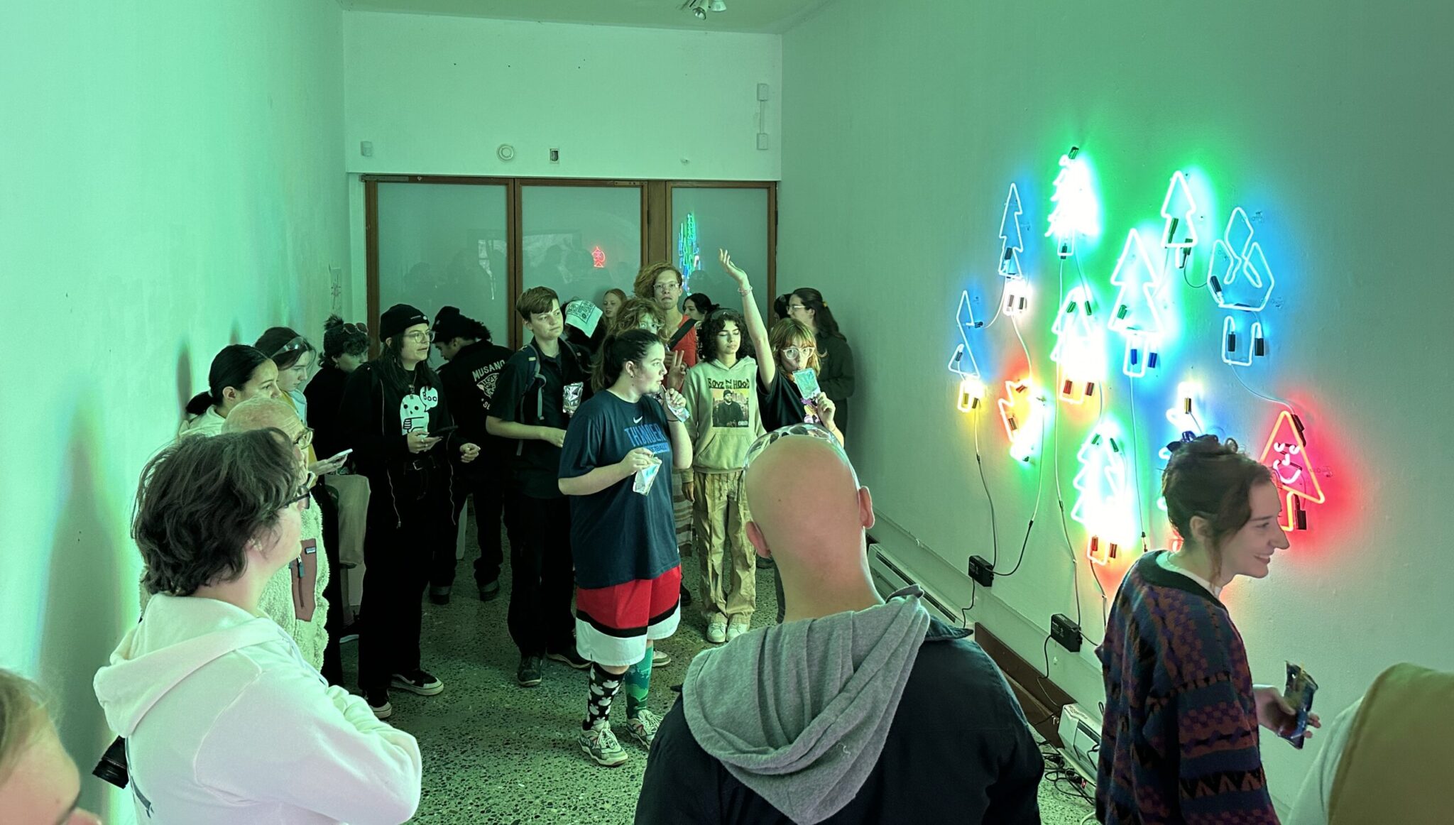 Hilltop Artists students at the Pilchuck Glass School view their group neon project, “Glow Together, Grow Together"