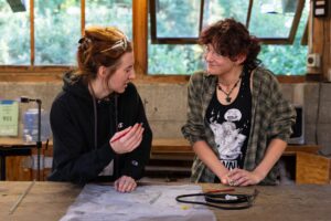 Teaching Artist Dani instructs current student Katie during a lesson on neon at Pilchuck