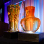 Two signature glass centerpieces displayed in front of the stage at the 2025 Better Futures Luncheon.