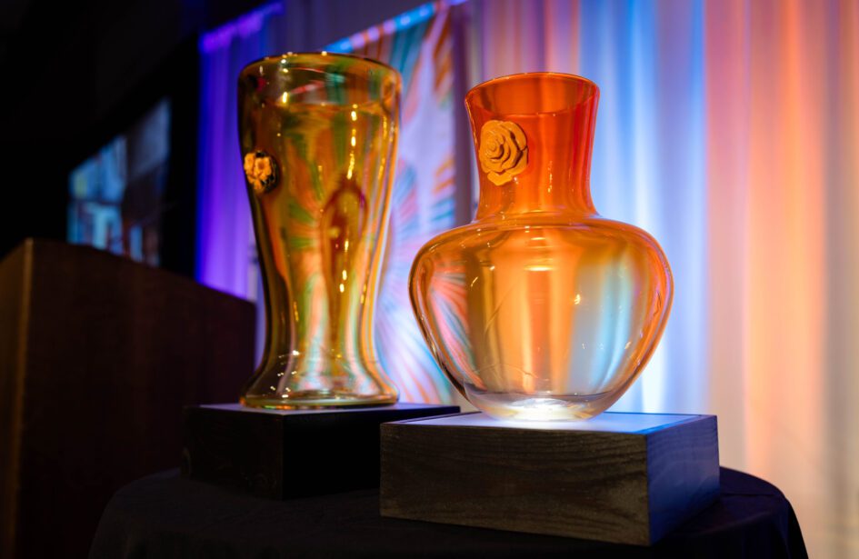 Two signature glass centerpieces displayed in front of the stage at the 2025 Better Futures Luncheon.