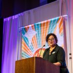 Photograph of Dr. Kim Keith speaking at the 2025 Better Futures Luncheon