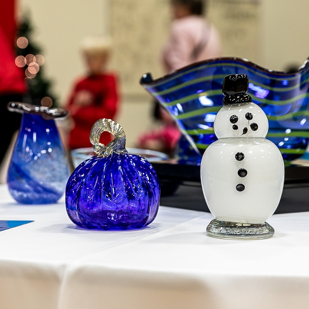 Photograph of glass vessels and sculptures on a table at the Winter Glass Sale.