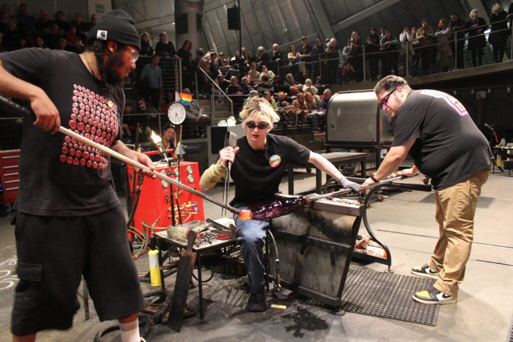 Program Manager Zane assists students during the residency at Museum of Glass, 2024.
