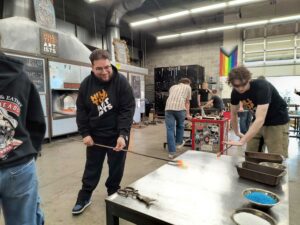 Instructors Luis and Zane work on commission pieces in the Hilltop Artists hot shop.