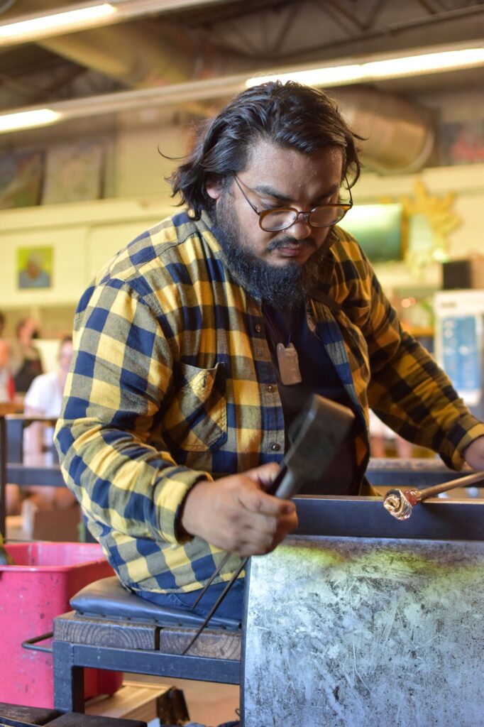 Hilltop Artists alumni David Rios during an Arts Night Out demonstration in the hot shop.