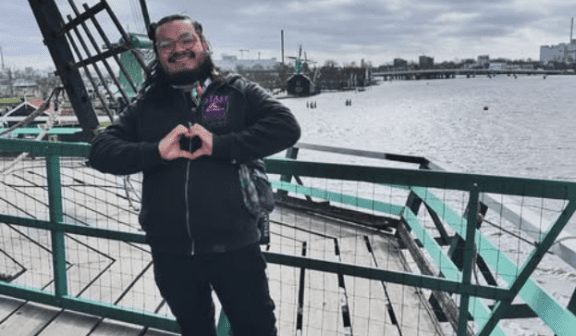 David Rios posed on a bridge during a trip